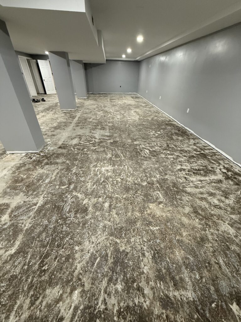 Basement epoxy flooring installation with moisture barrier in Enfield CT by Northern Epoxy Pros